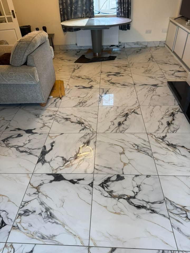 Finished large-format Calacatta marble floor through living space