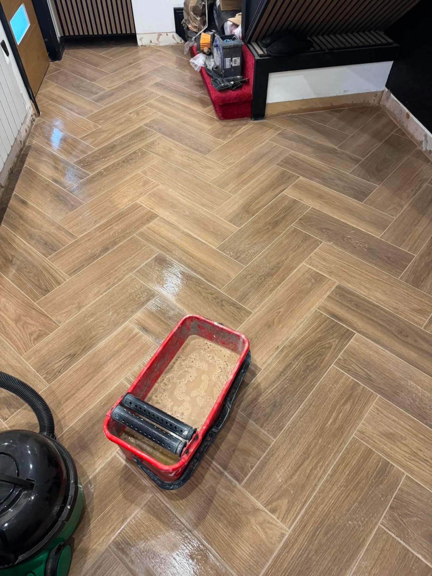 Herringbone install — close-up with tools