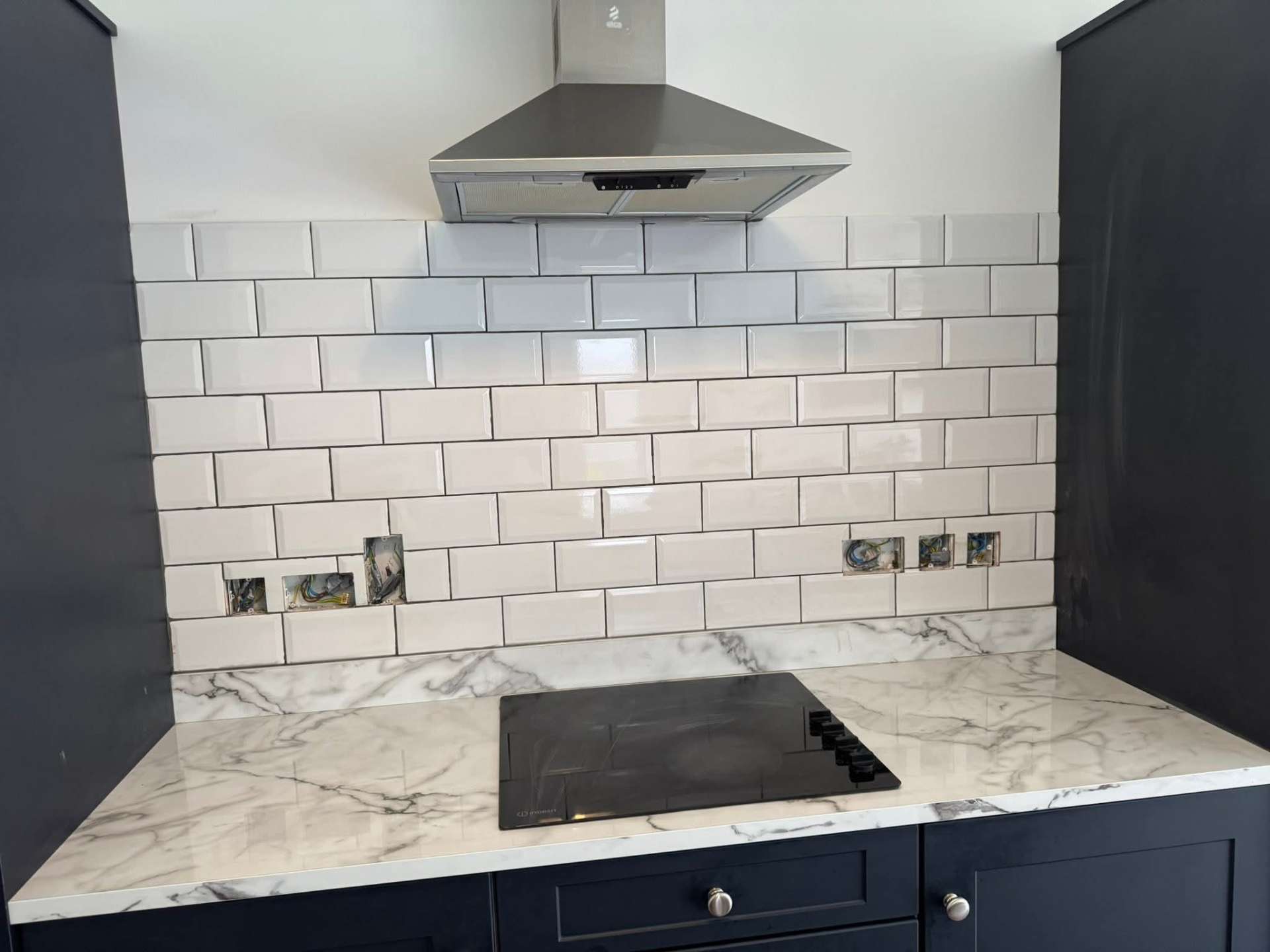Navy shaker — finished metro splashback closeup at hood