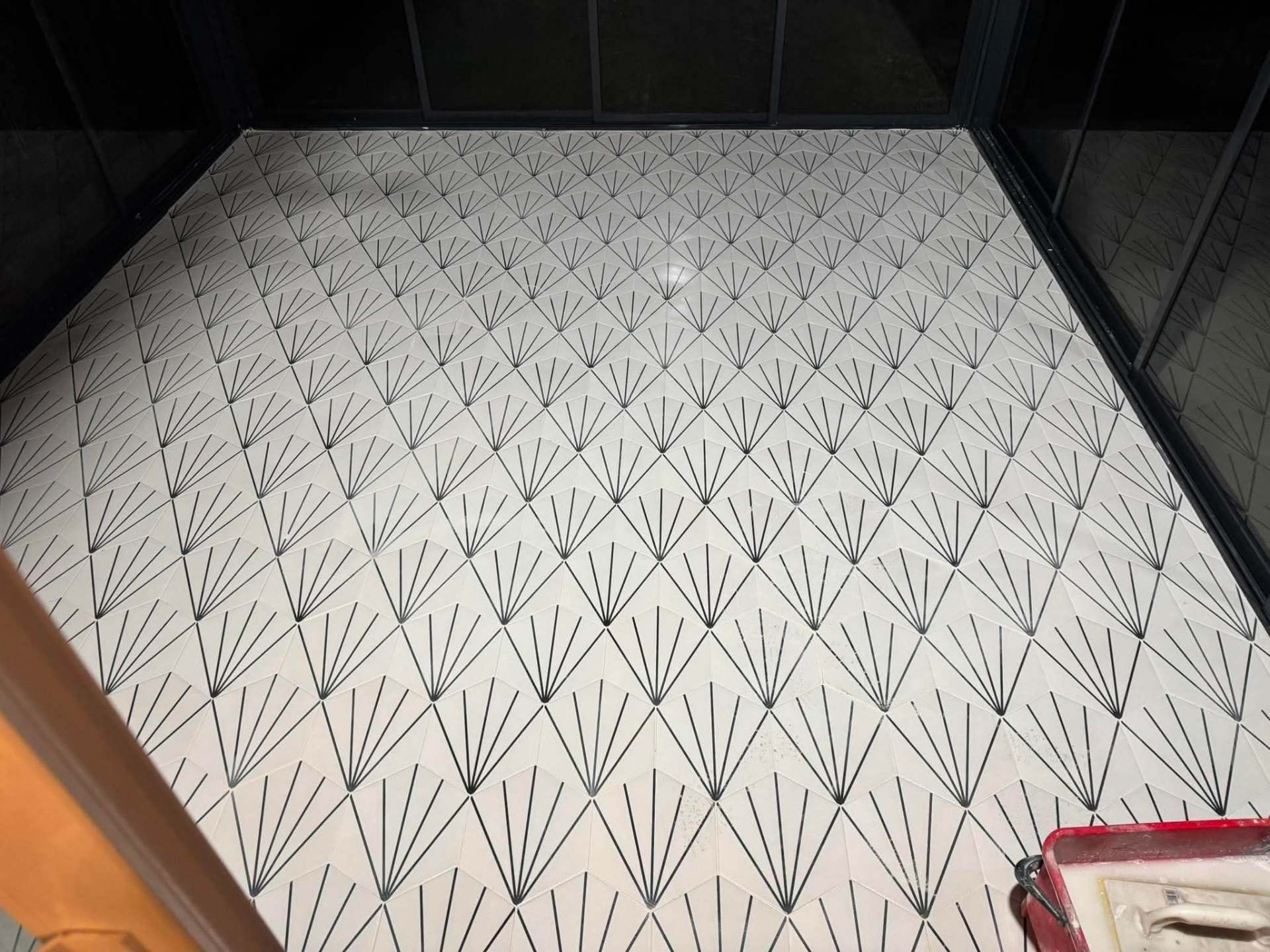 Art-deco fan tile — finished section, entryway angle