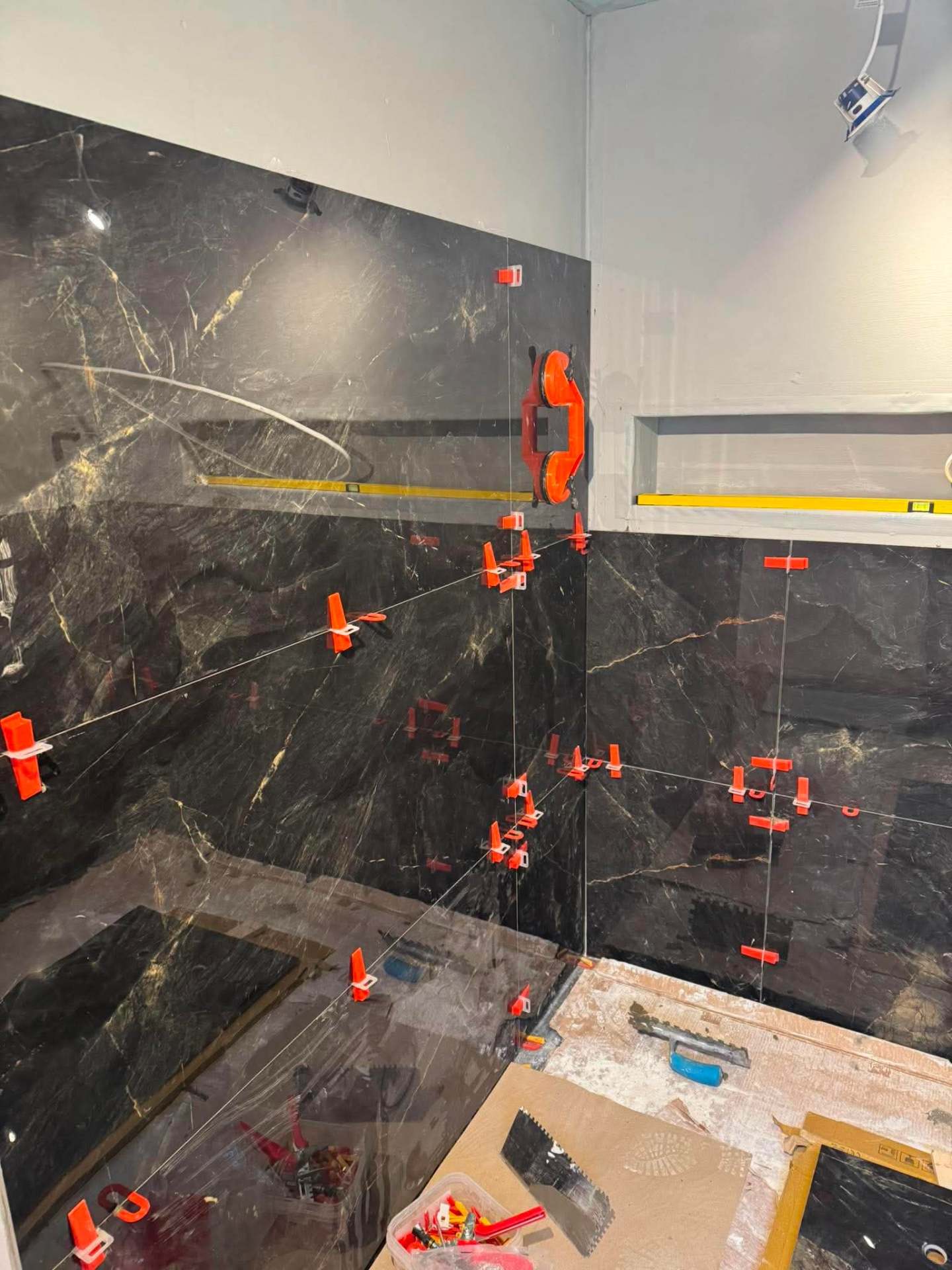 Dark marble shower wall taking shape