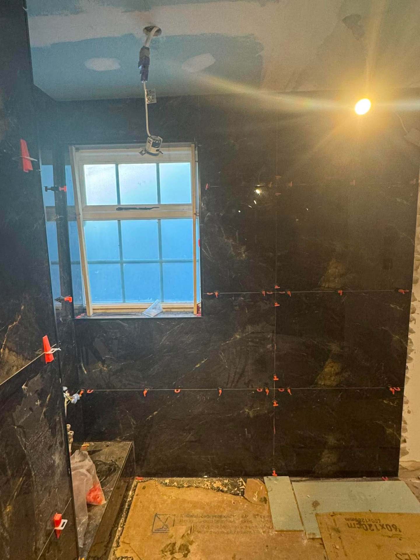 Dark marble shower walls — install with hose hanging
