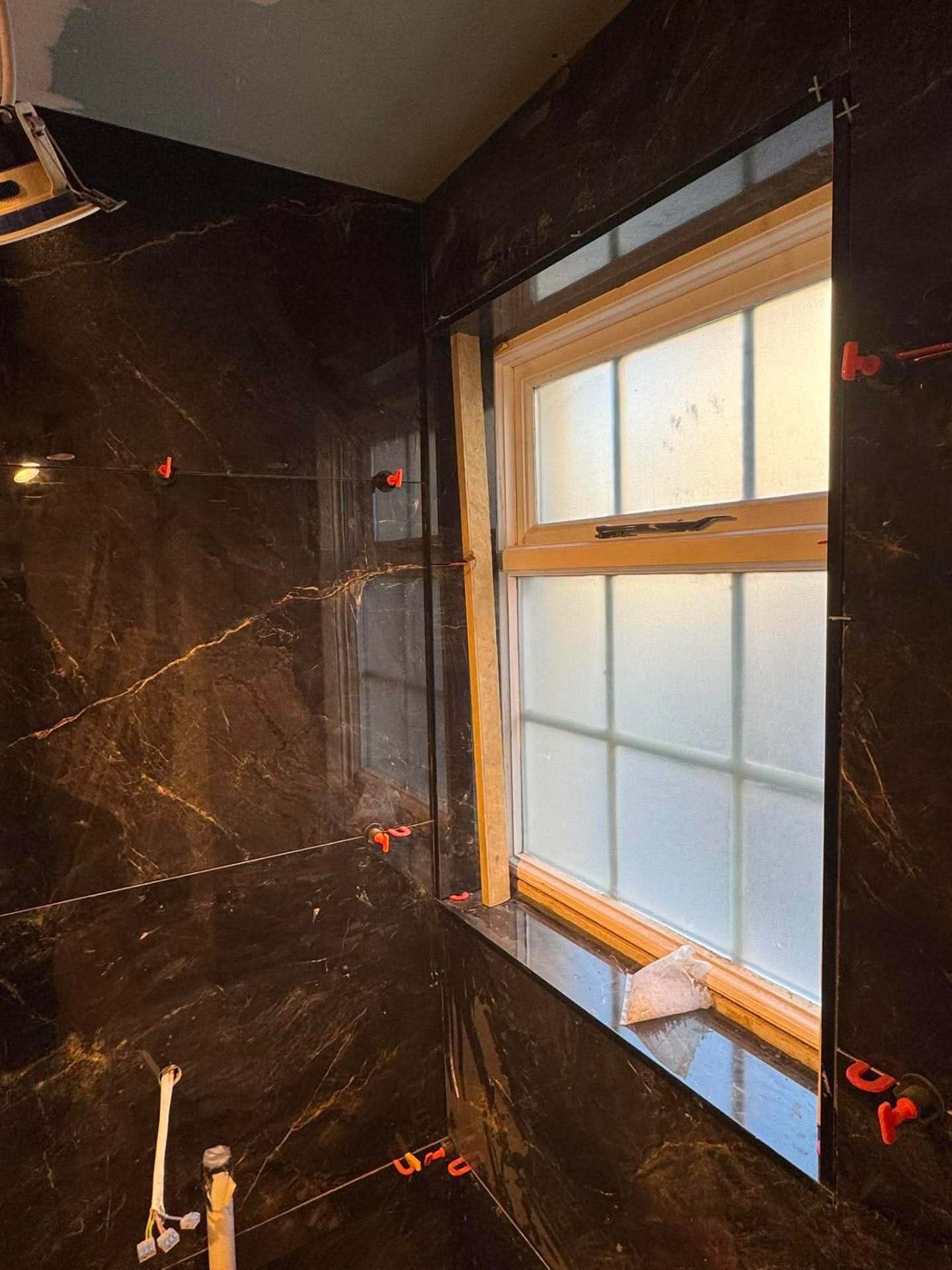 Dark marble install — sash window reveal
