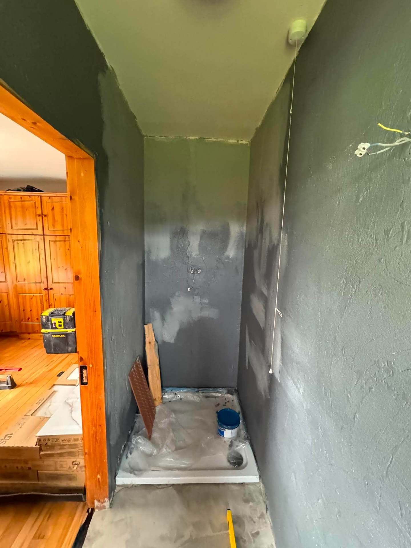 Small bathroom mid-prep with door reveal cleared