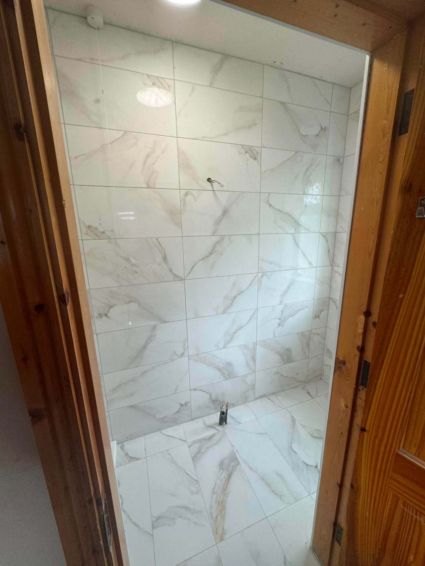 Calacatta marble shower — finished with door open
