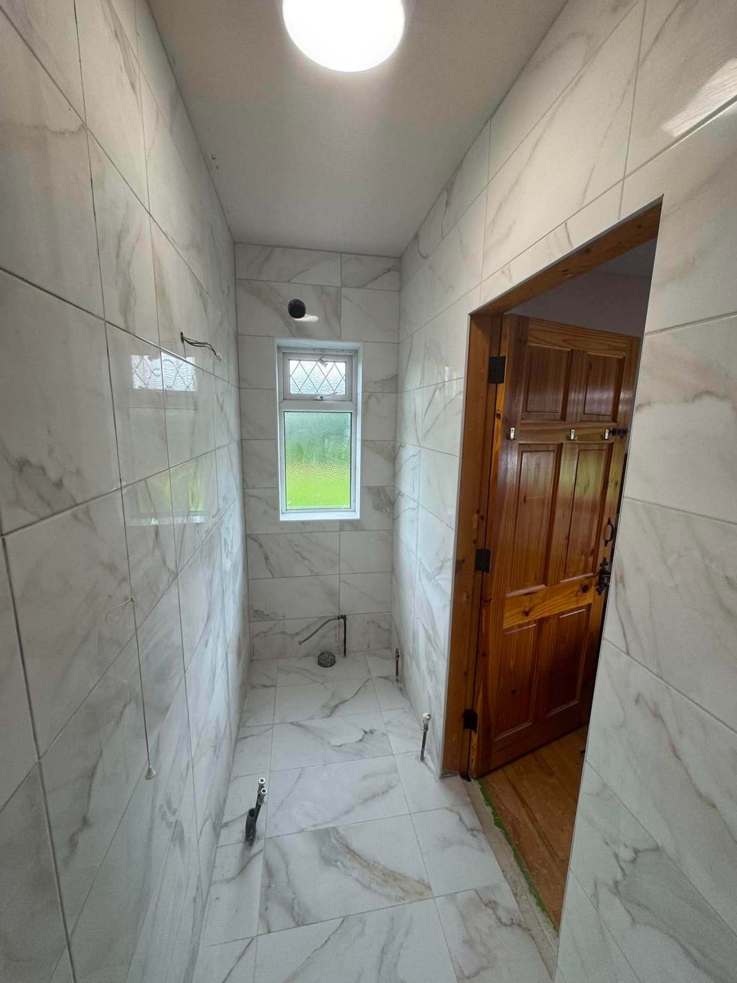 Calacatta marble — finished walk-through corridor