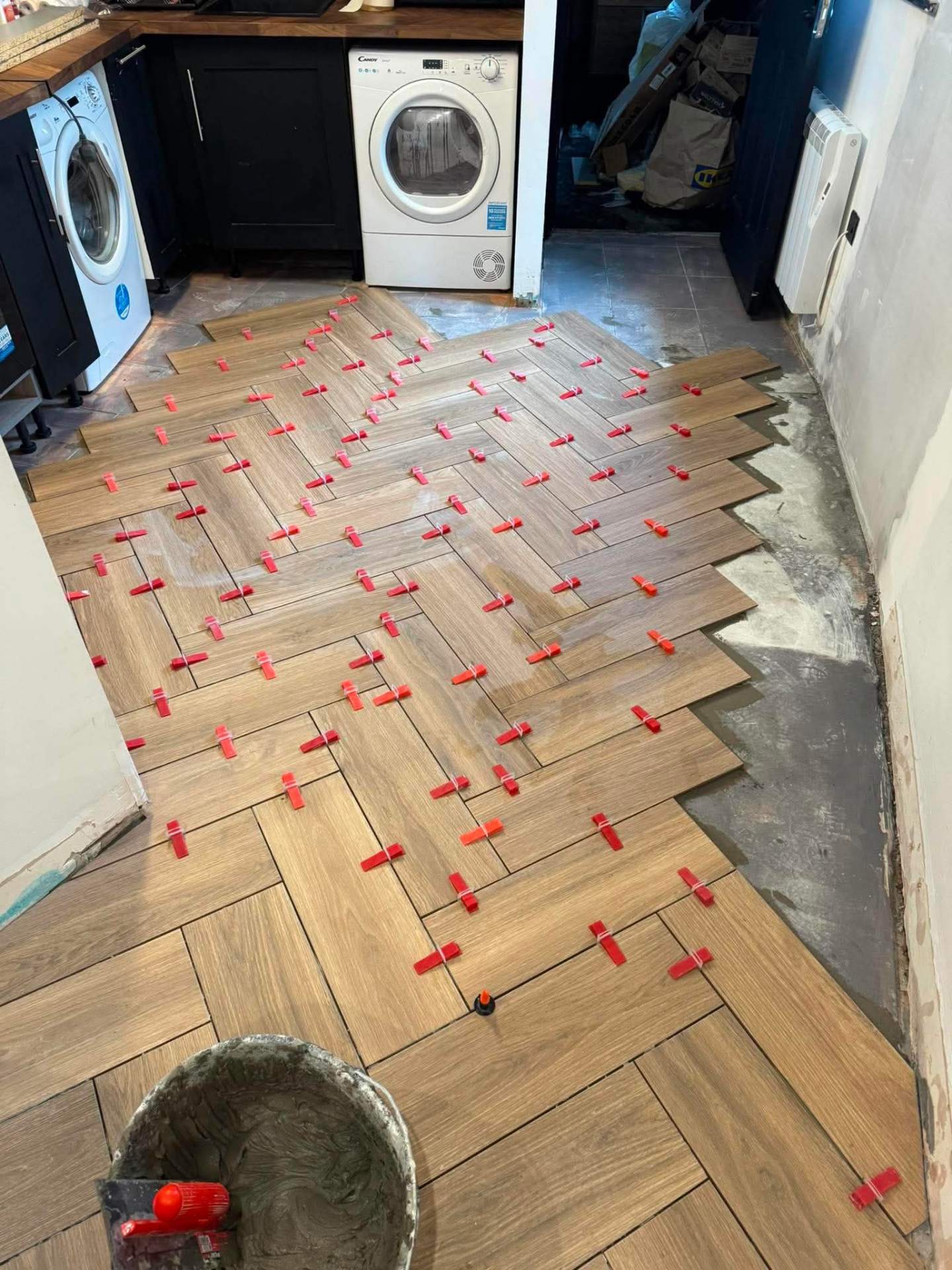 Herringbone install — utility room with appliances in shot