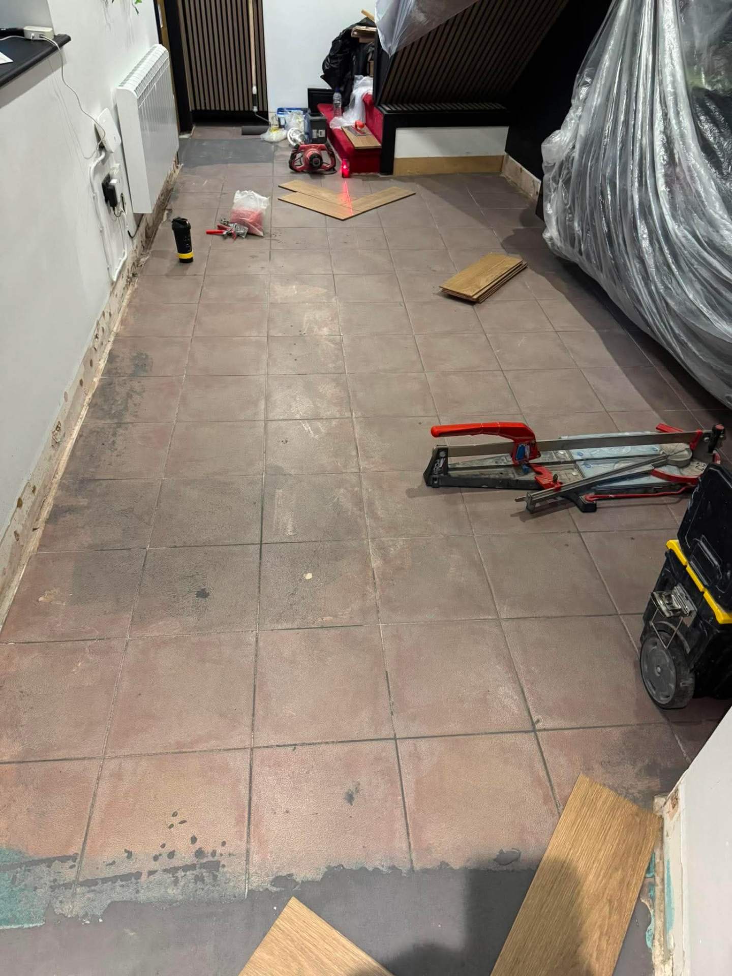 Calacatta marble floor mid-install with tools in shot