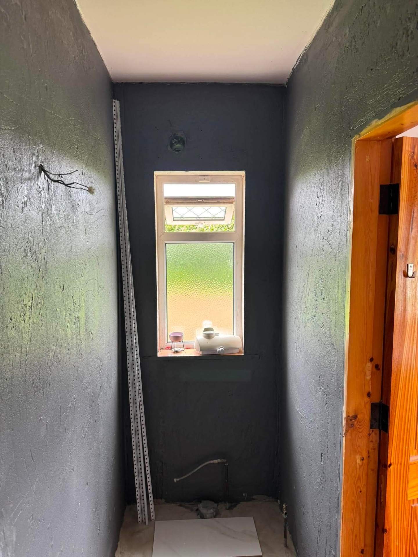 Small WC corridor — dark plaster primed and ready