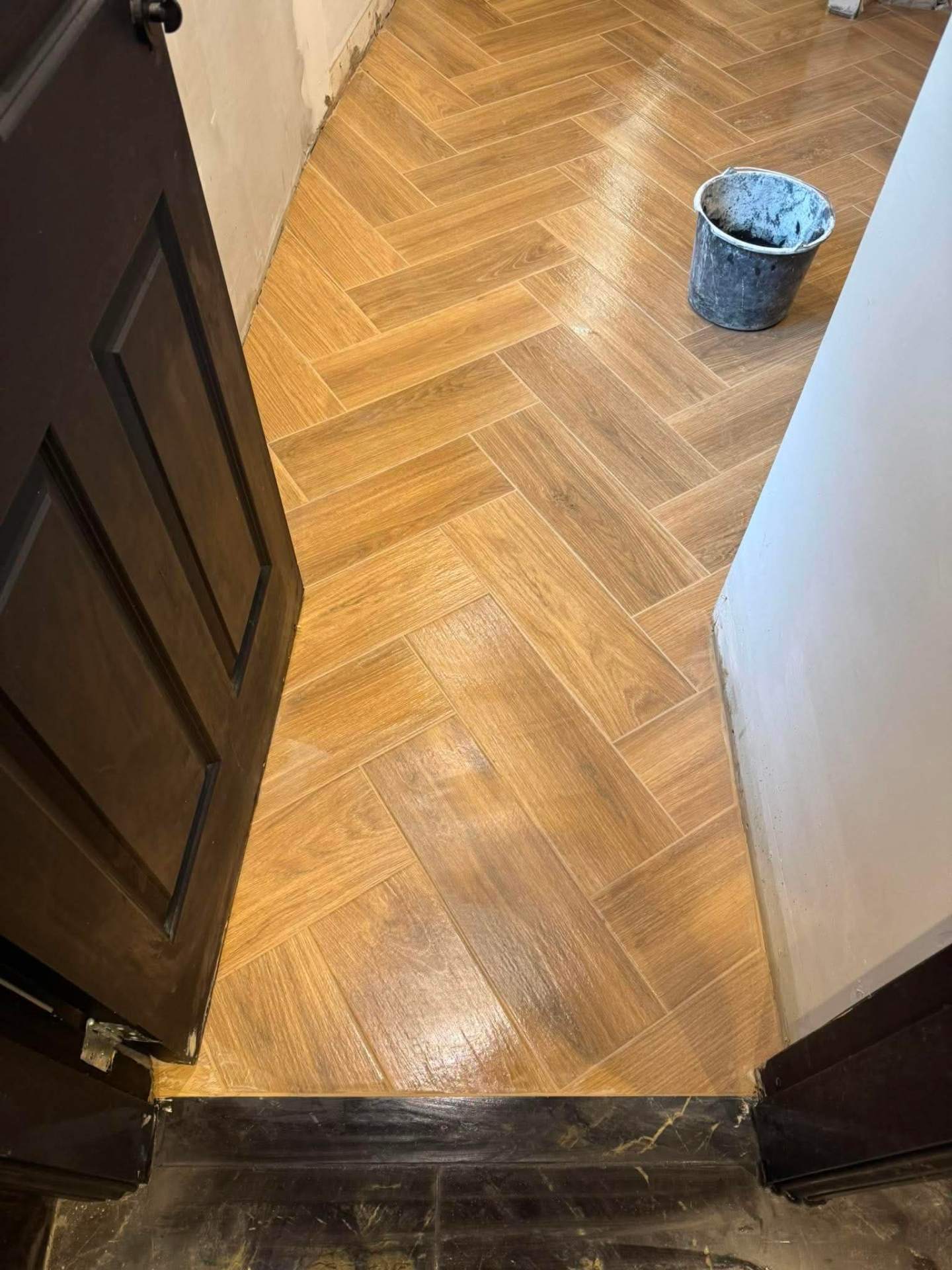 Finished herringbone — clean threshold through doorway